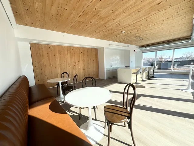 a view of a dining room with furniture and window