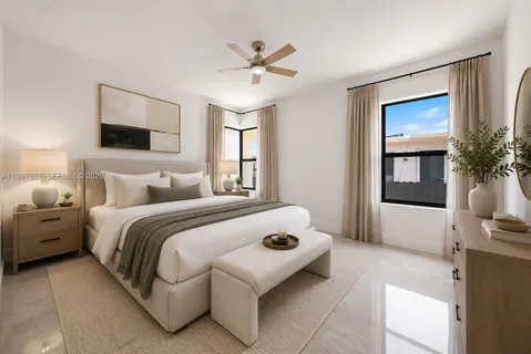 a bedroom with a bed and a potted plant