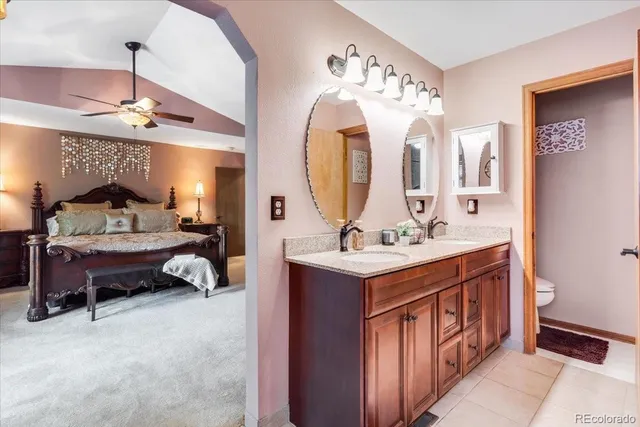 a en suite bathroom with a double vanity sink and a mirror