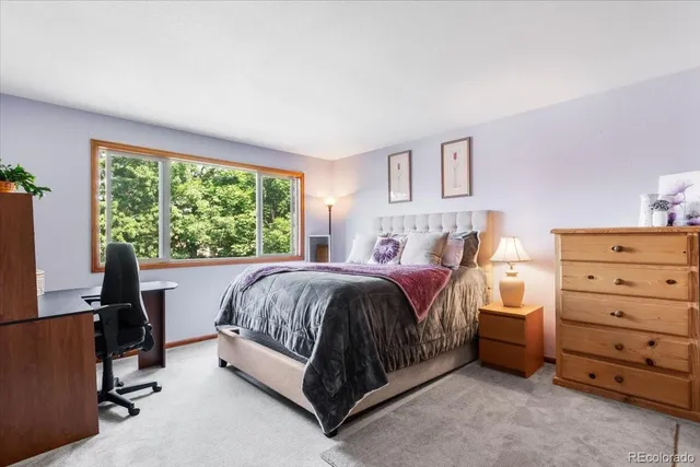 a bed sitting in a room next to a window