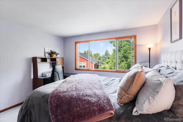 a bed sitting in a bedroom next to a window