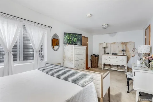 a bedroom with a bed and cabinets