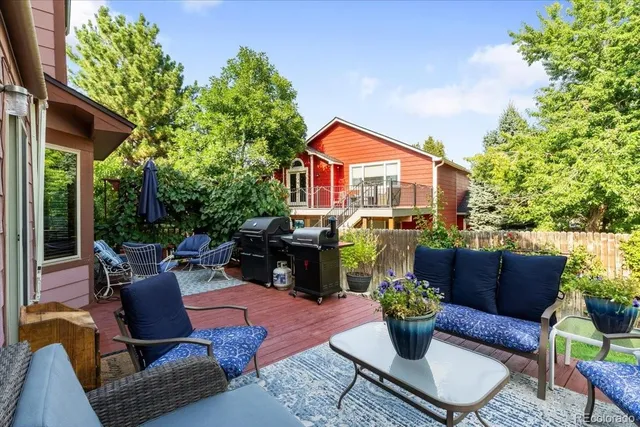 a view of a patio with couches table and chairs and potted plants