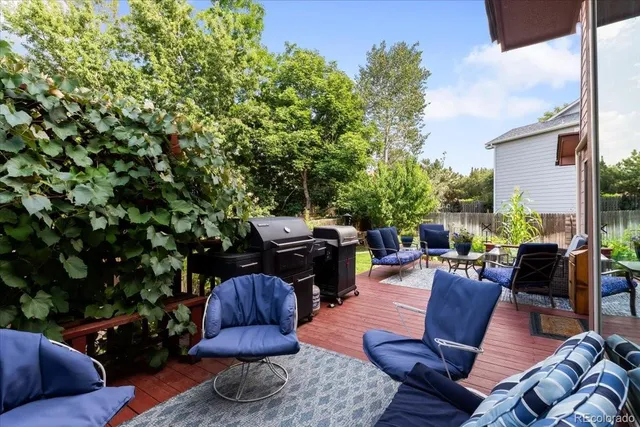 a view of a backyard with furniture and a fire pit