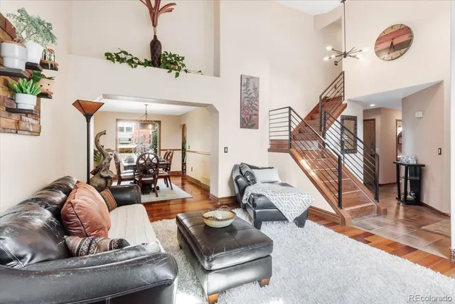 a living room with furniture and a chandelier