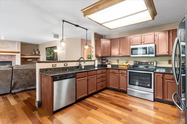 a kitchen with stainless steel appliances granite countertop a stove and a sink