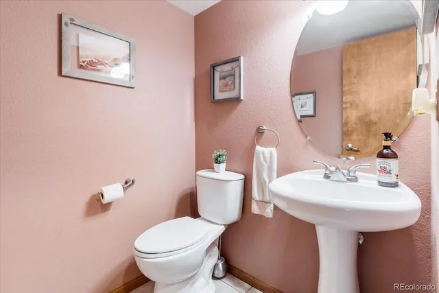 a bathroom with a sink mirror and toilet