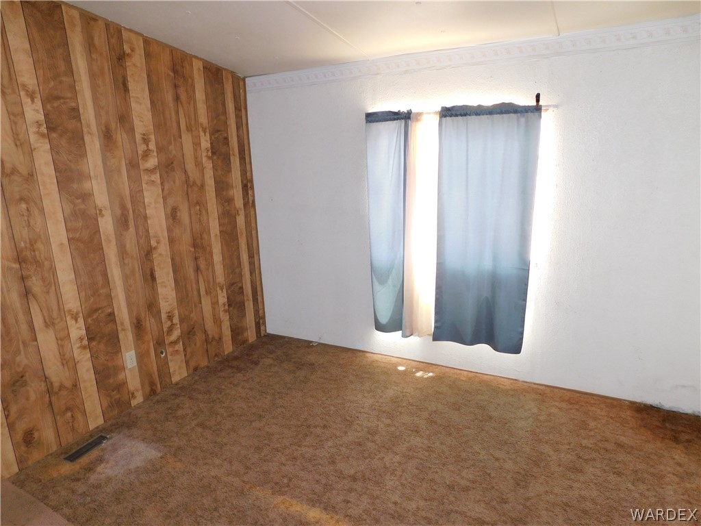 3539 Mobile Road Golden Valley, AZ 86413 - Photo 14 of 18 a view of an empty room with wooden floor