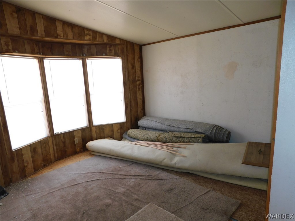 3539 Mobile Road Golden Valley, AZ 86413 - Photo 17 of 18 a bedroom with a bed and wooden floor