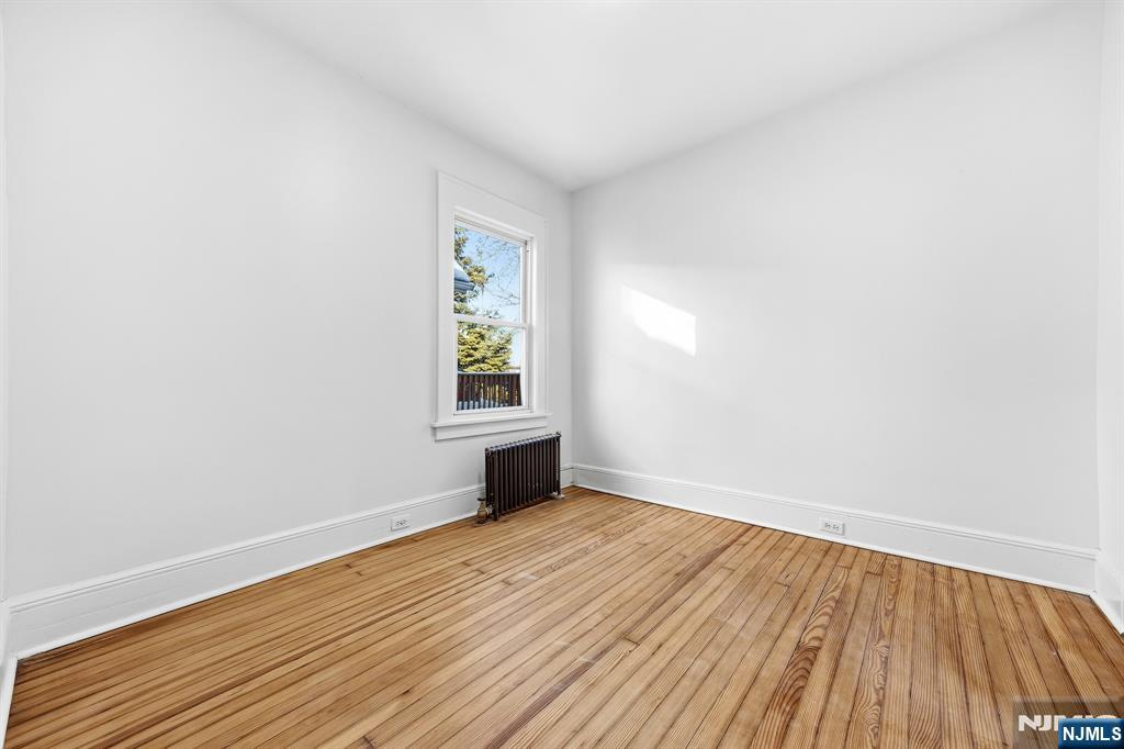 159 2nd Avenue Hawthorne, NJ 07506 - Photo 12 of 26 an empty room with wooden floor and windows