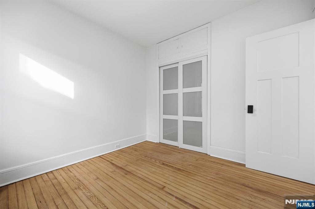 159 2nd Avenue Hawthorne, NJ 07506 - Photo 13 of 26 a view of empty room with wooden floor and fan