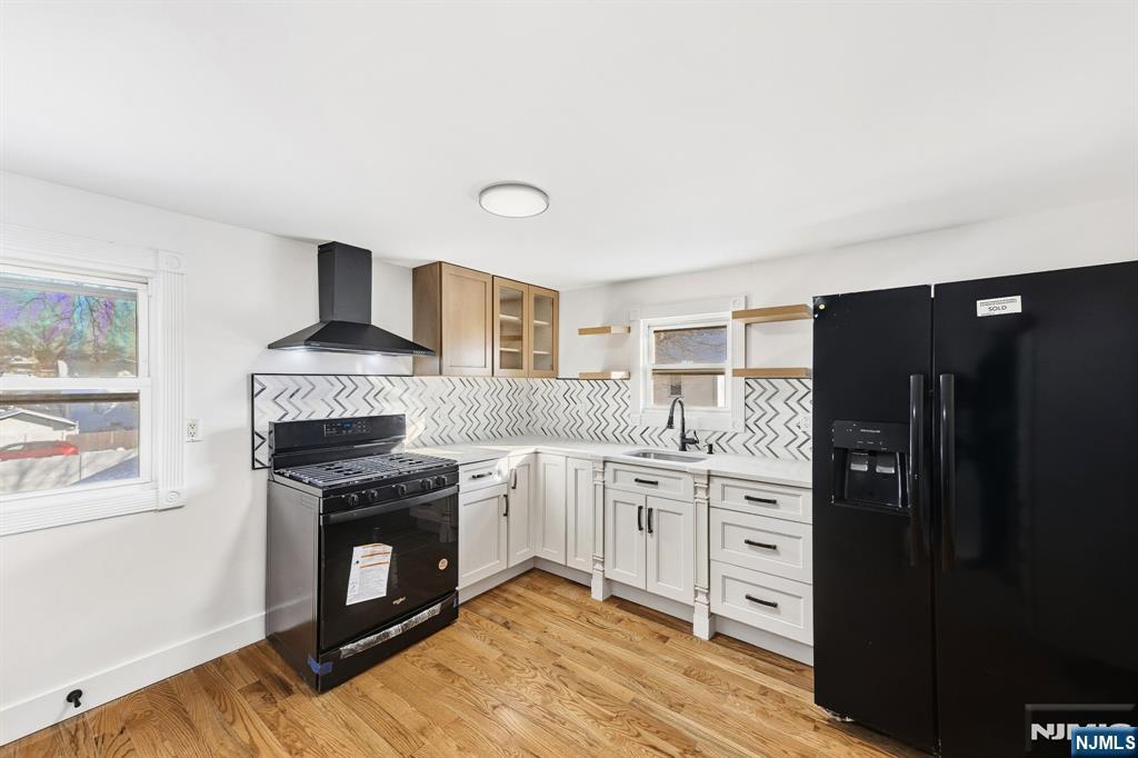 159 2nd Avenue Hawthorne, NJ 07506 - Photo 15 of 26 a kitchen with stainless steel appliances a stove sink and refrigerator