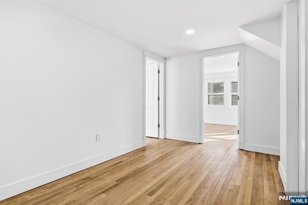 159 2nd Avenue Hawthorne, NJ 07506 - Photo 17 of 26 an empty room with wooden floor and windows