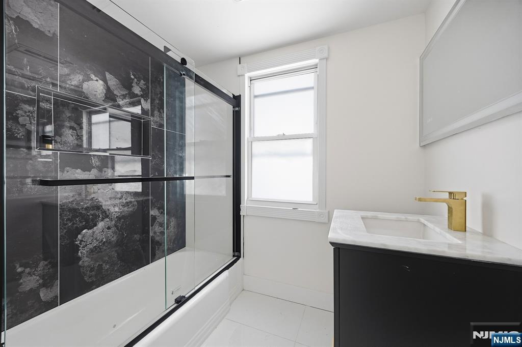 159 2nd Avenue Hawthorne, NJ 07506 - Photo 18 of 26 a bathroom with a sink and mirror