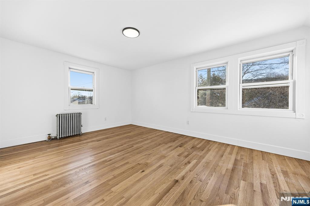 159 2nd Avenue Hawthorne, NJ 07506 - Photo 19 of 26 a view of empty room with wooden floor and fan