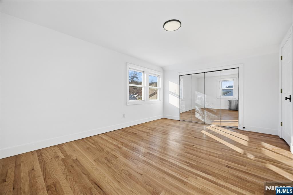 159 2nd Avenue Hawthorne, NJ 07506 - Photo 20 of 26 a view of empty room with wooden floor and fan
