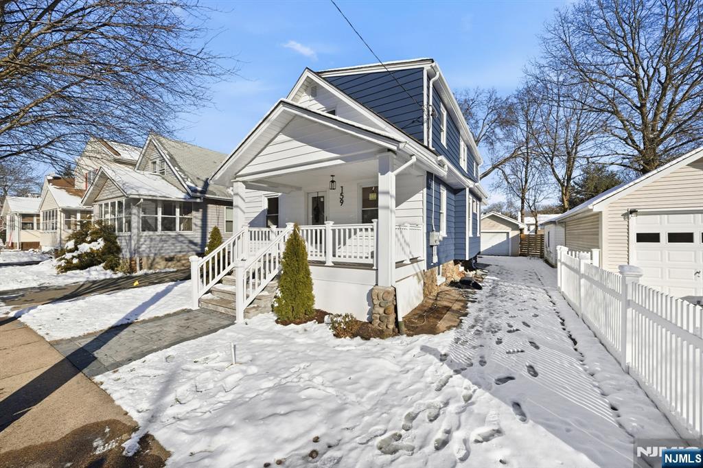 159 2nd Avenue Hawthorne, NJ 07506 - Photo 2 of 26 a view of a house with snow on the background