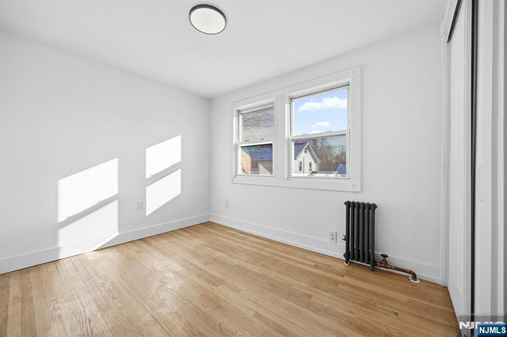 159 2nd Avenue Hawthorne, NJ 07506 - Photo 21 of 26 an empty room with wooden floor and windows