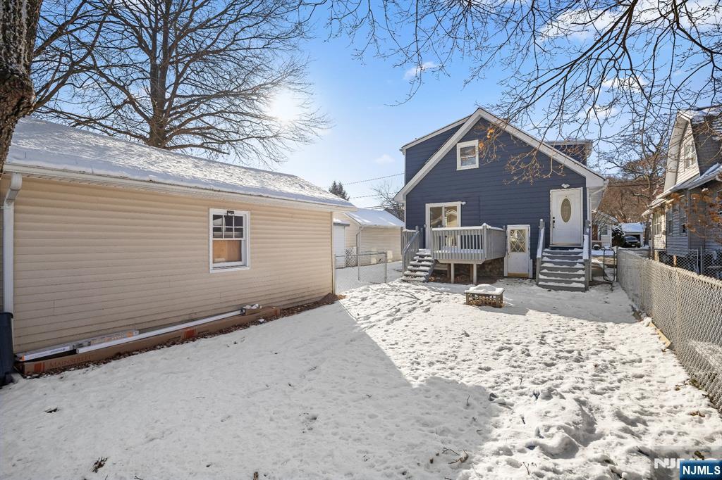 159 2nd Avenue Hawthorne, NJ 07506 - Photo 25 of 26 a front view of a house with a yard covered in snow