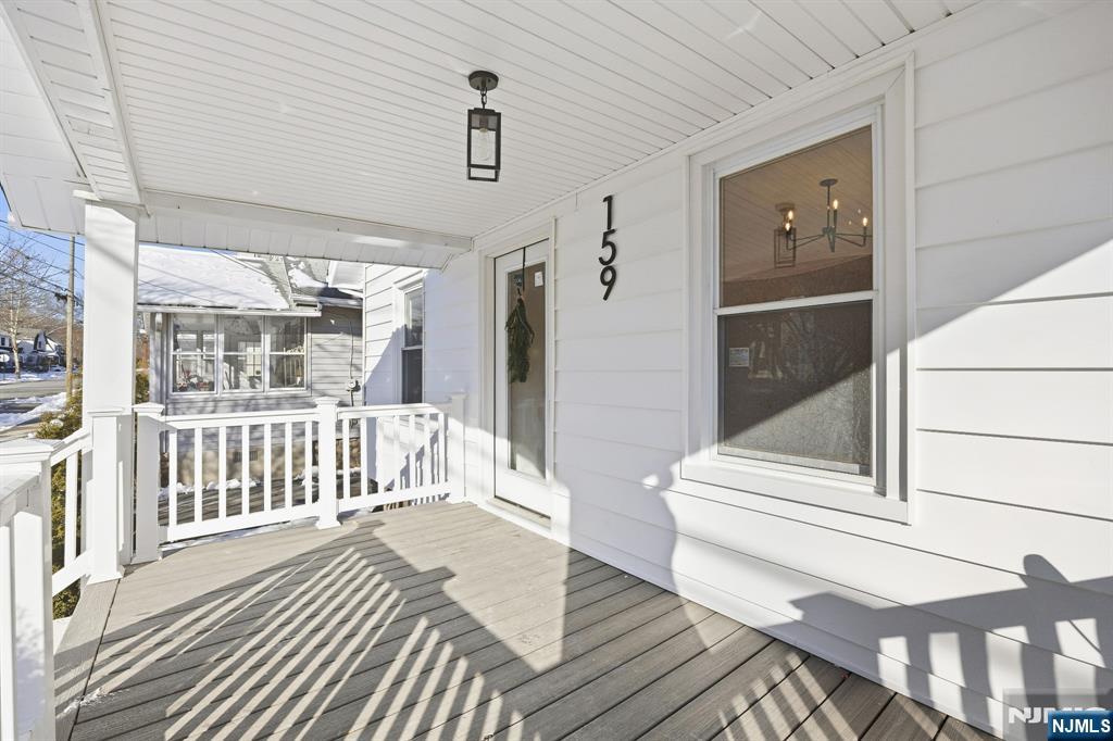 159 2nd Avenue Hawthorne, NJ 07506 - Photo 3 of 26 a view of a balcony with wooden floor and iron gate