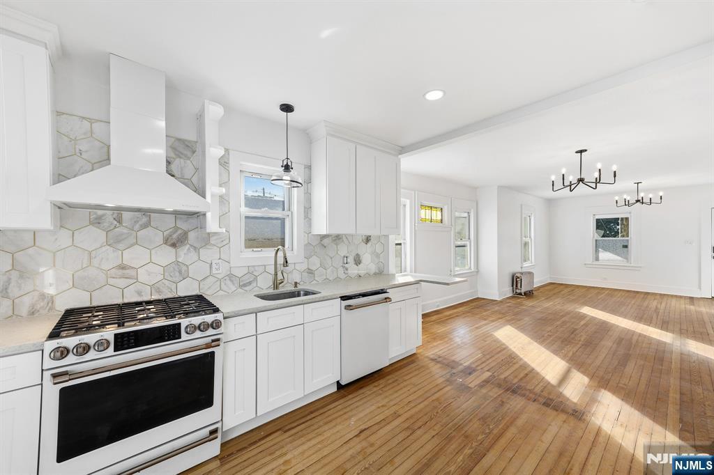 159 2nd Avenue Hawthorne, NJ 07506 - Photo 4 of 26 a kitchen with stainless steel appliances a sink stove and cabinets