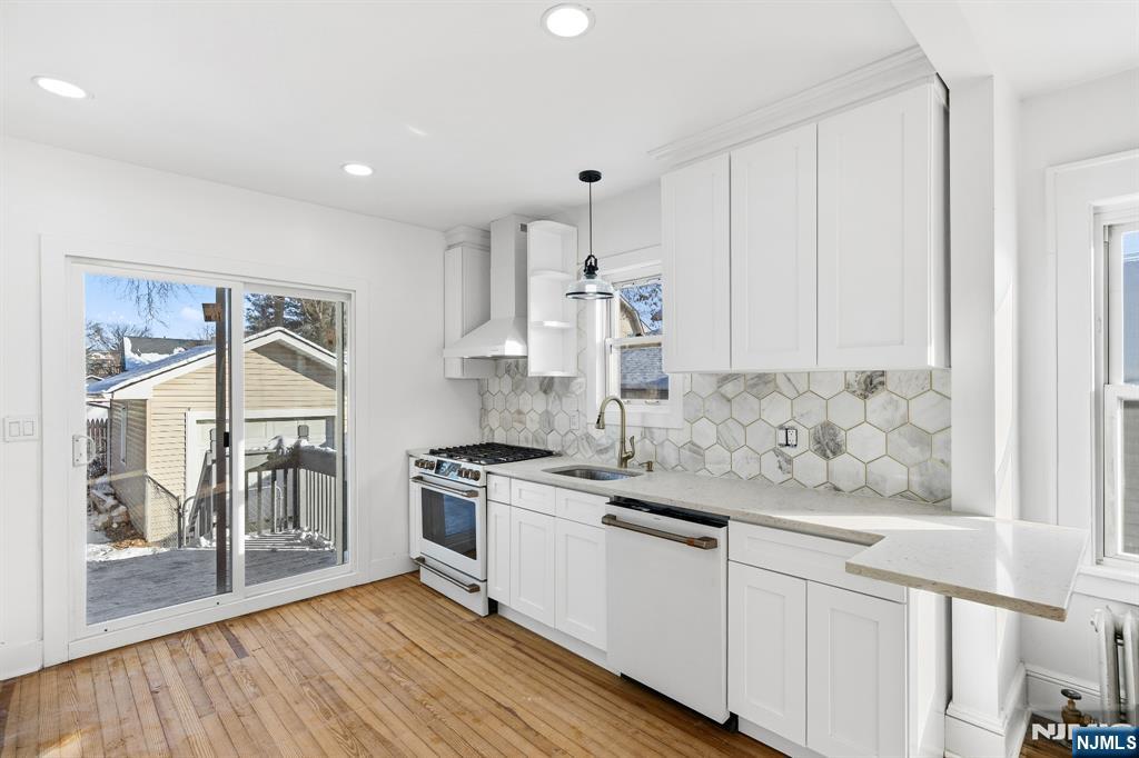 159 2nd Avenue Hawthorne, NJ 07506 - Photo 6 of 26 a kitchen with stainless steel appliances granite countertop a stove and a wooden floors