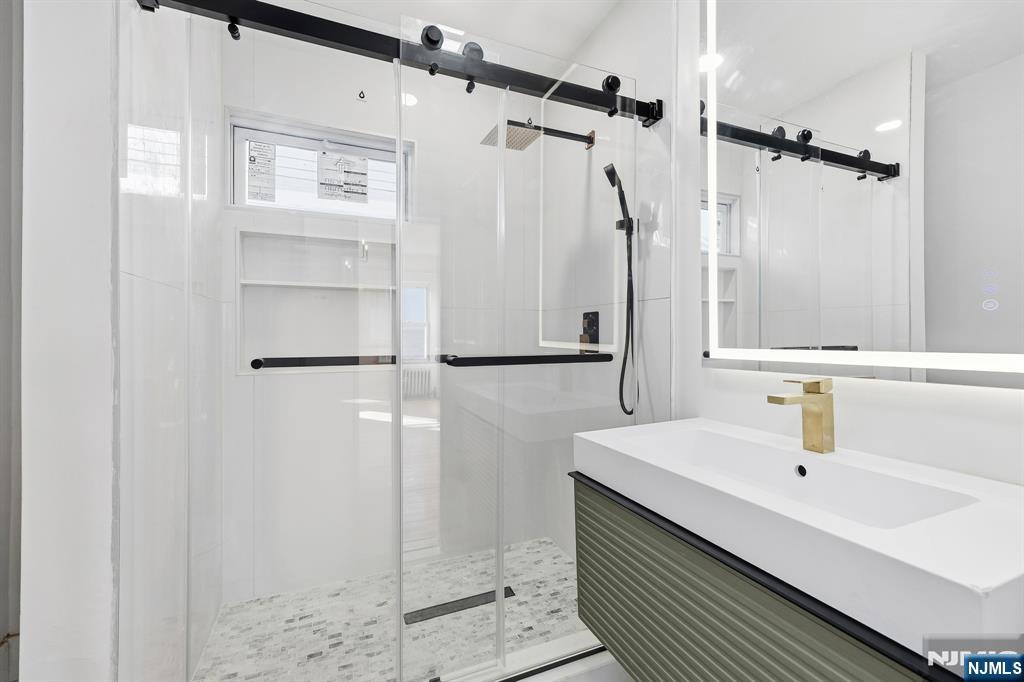 159 2nd Avenue Hawthorne, NJ 07506 - Photo 10 of 26 a bathroom with a sink and a mirror