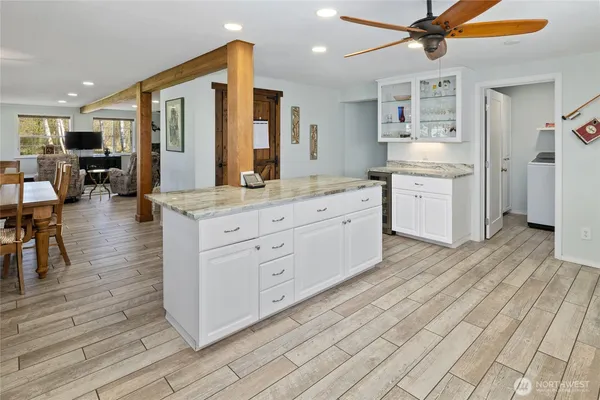 a large kitchen with stainless steel appliances a large counter top a sink a stove and a refrigerator