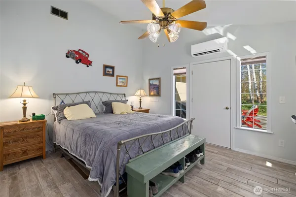 a bedroom with a bed and a chandelier