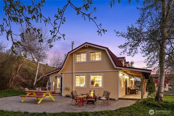 a view of a house with a backyard porch and sitting area