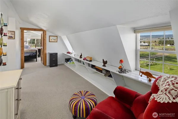 a room with furniture gym equipment and a large window