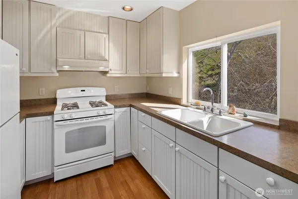 a kitchen with sink cabinets and window