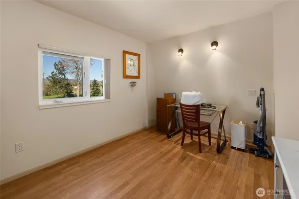 a view of a workspace with furniture and a window