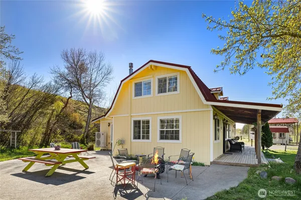 a backyard of a house with table and chairs