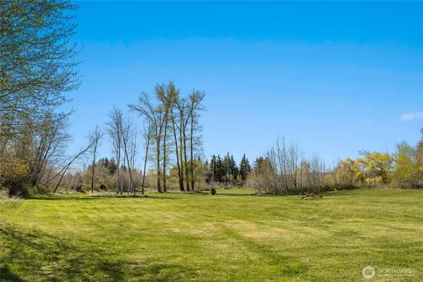 a front view of a house with a yard table and chairs