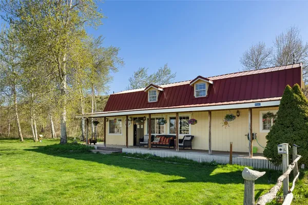 a view of a house with a yard patio and fire pit