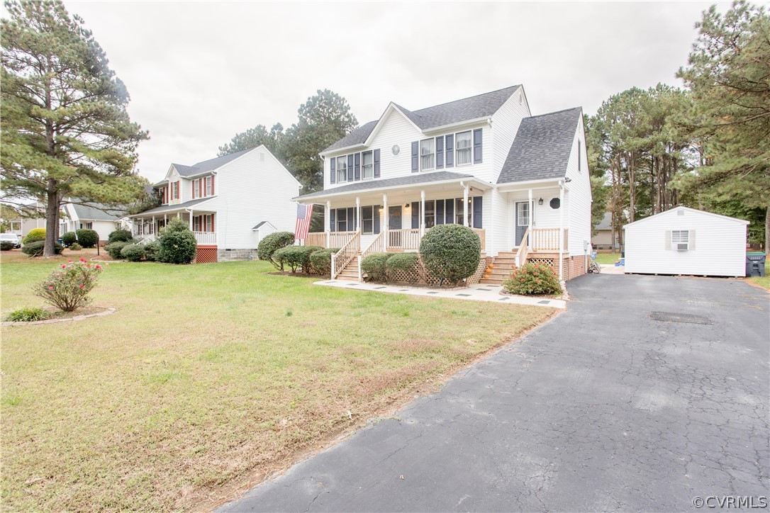 7487 Trailing Rock Road Prince George, VA 23875 - Photo 8 of 33 a view of a house with a yard and large trees