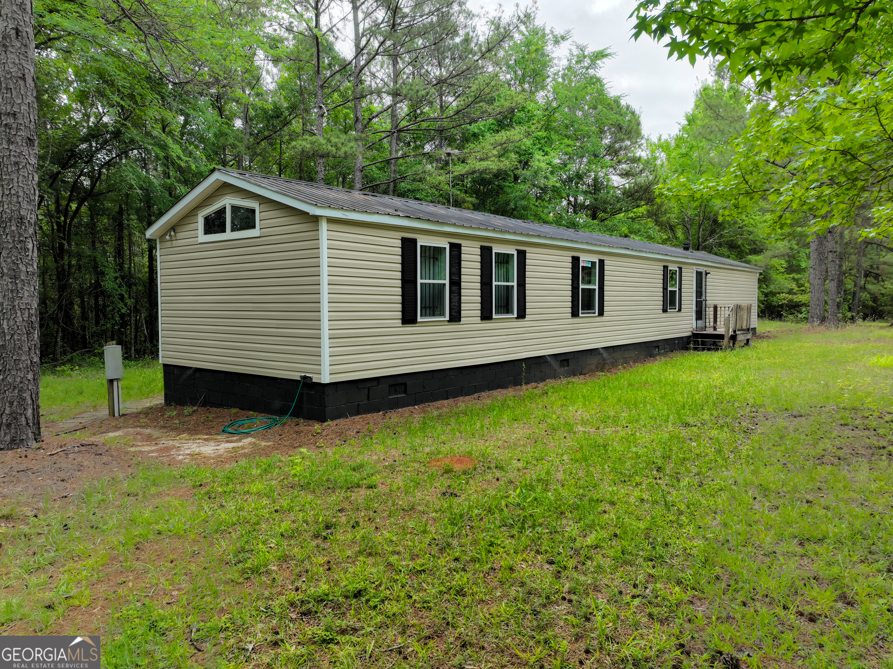 1099 Dixon Road Sparta, GA 31087 - Photo 17 of 51 a front view of a house with a yard