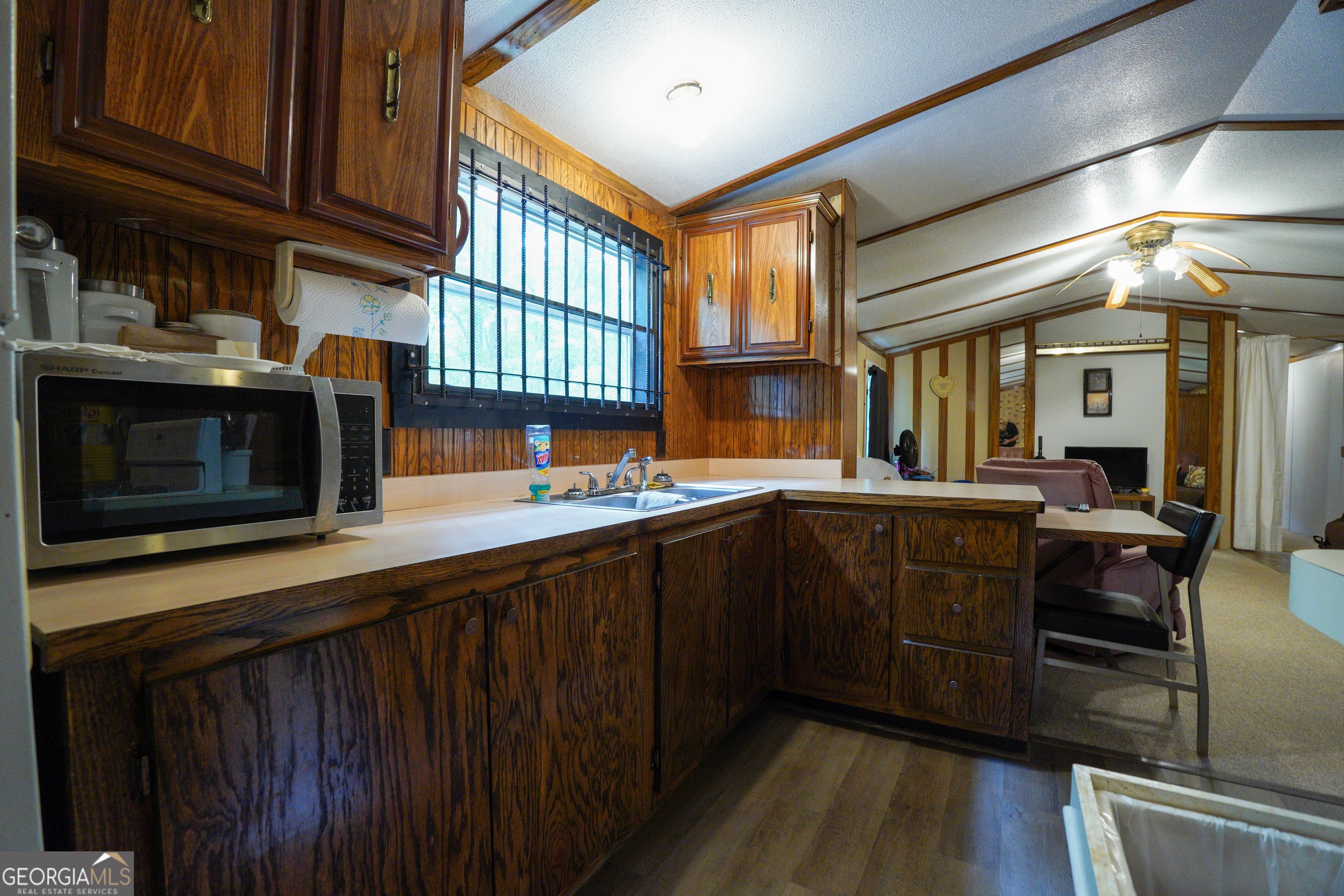 1099 Dixon Road Sparta, GA 31087 - Photo 19 of 51 a kitchen with stainless steel appliances granite countertop a stove a sink dishwasher and cabinets with wooden floor