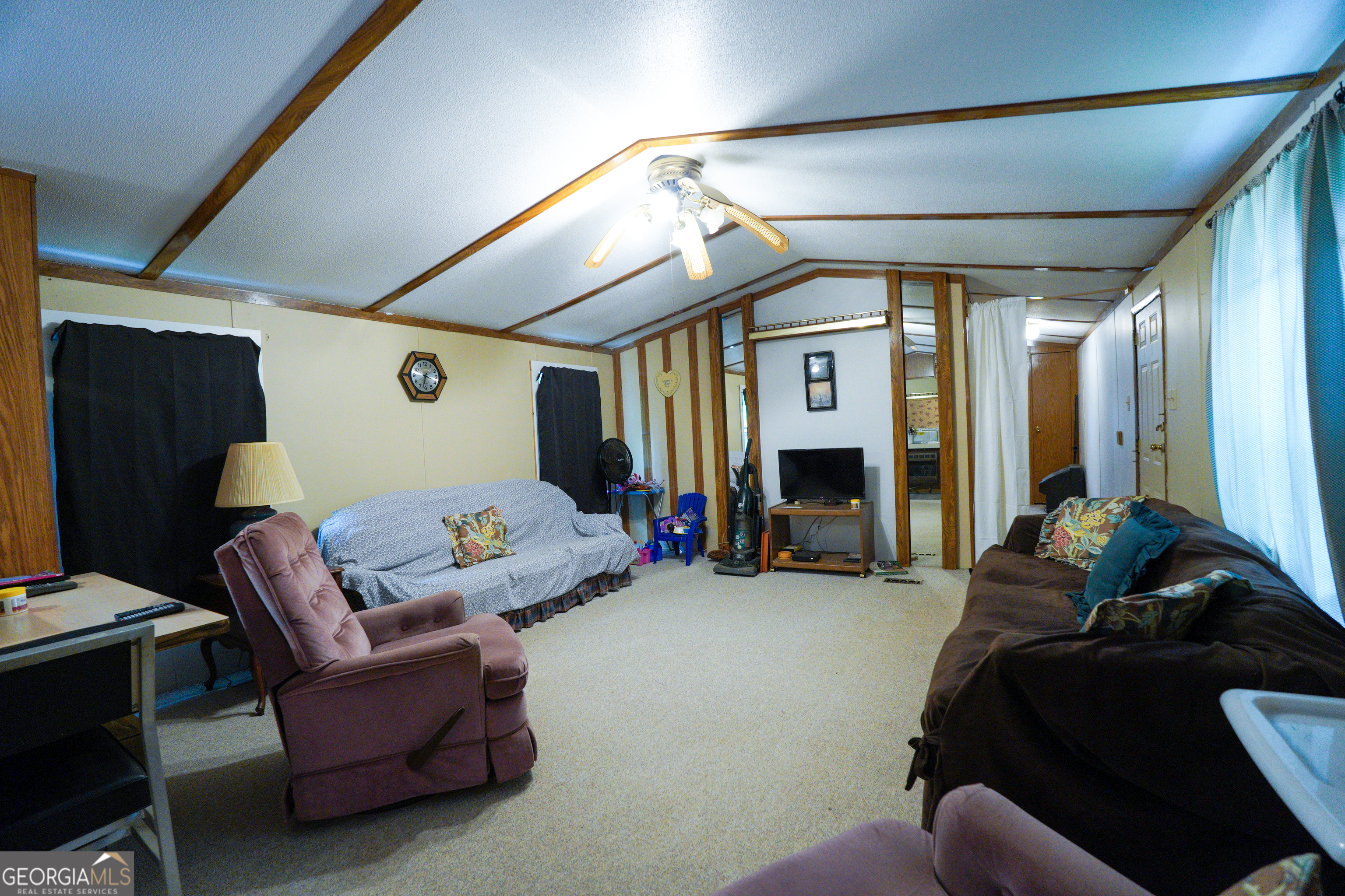 1099 Dixon Road Sparta, GA 31087 - Photo 24 of 51 a living room with furniture and a fireplace