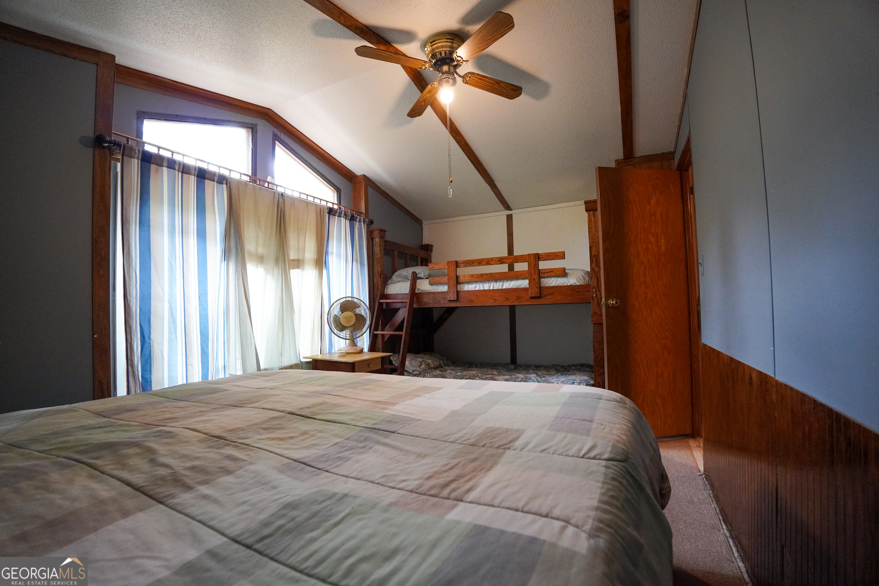 1099 Dixon Road Sparta, GA 31087 - Photo 27 of 51 a bedroom with a bed closet and wooden floor