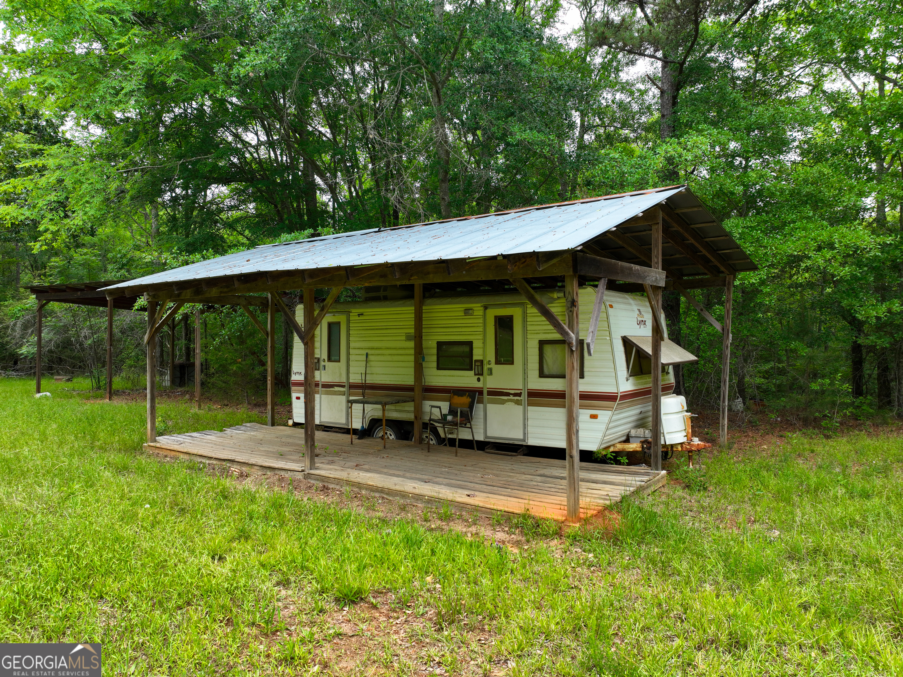 1099 Dixon Road Sparta, GA 31087 - Photo 32 of 51 a view of a house with a yard chairs and a table under an umbrella
