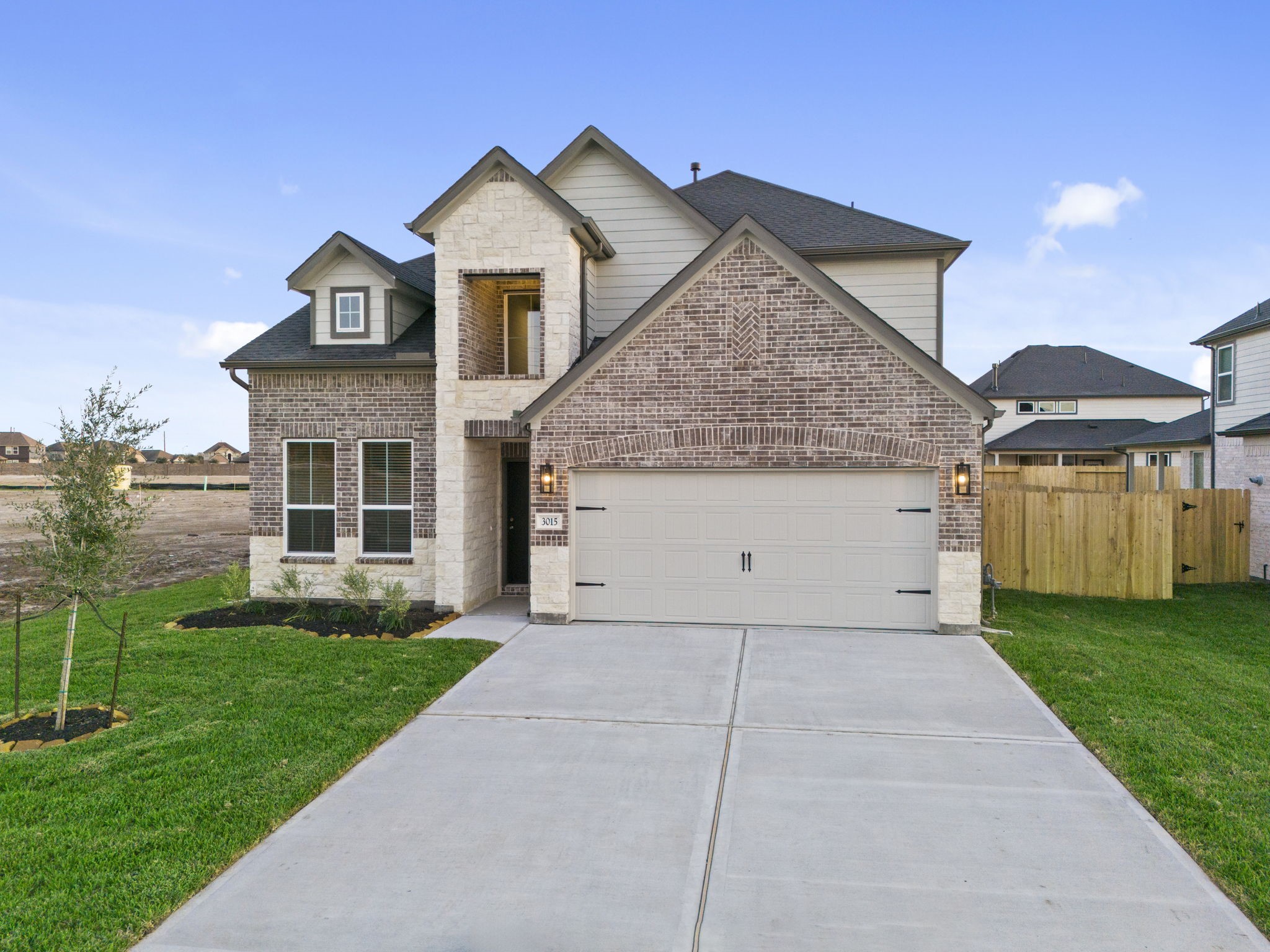 3015 Boulder Ridge Drive Rosenberg, TX 77471 - Photo 33 of 34 a front view of a house with a yard and garage
