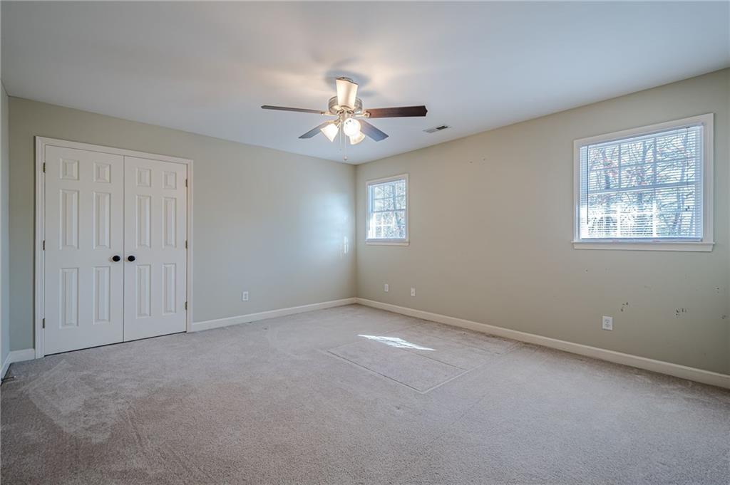 34 Johnston Row Northwest Cartersville, GA 30121 - Photo 57 of 95 an empty room with chandelier fan and windows