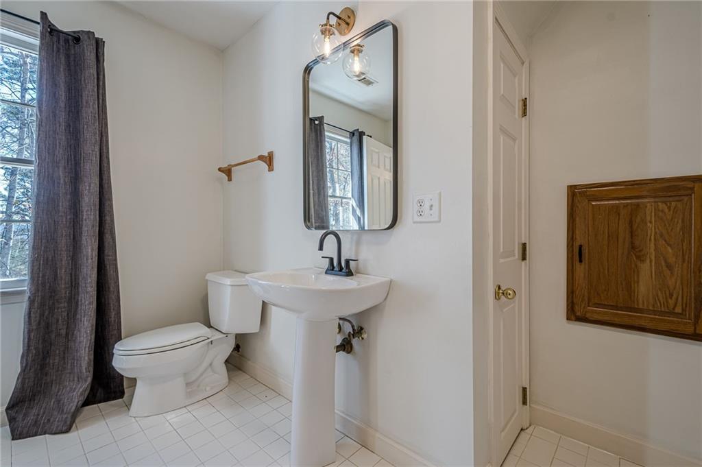 34 Johnston Row Northwest Cartersville, GA 30121 - Photo 62 of 95 a bathroom with a toilet sink and mirror