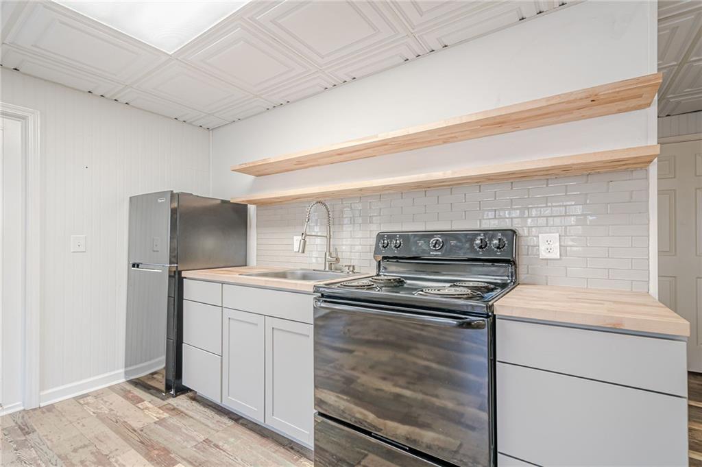 34 Johnston Row Northwest Cartersville, GA 30121 - Photo 72 of 95 a kitchen with a stove cabinets and wooden floor