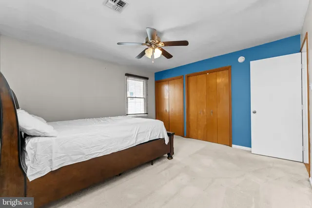 a bed room with a bed and a window