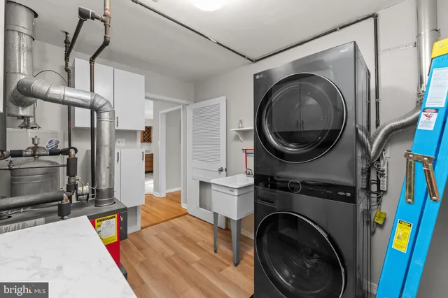 a living room with furniture and a washing machine