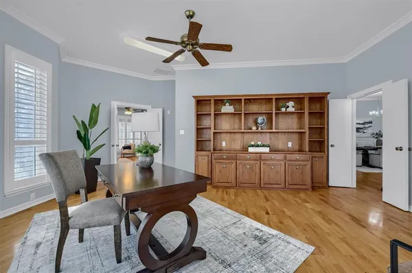 a living room with furniture a rug and a bookshelf