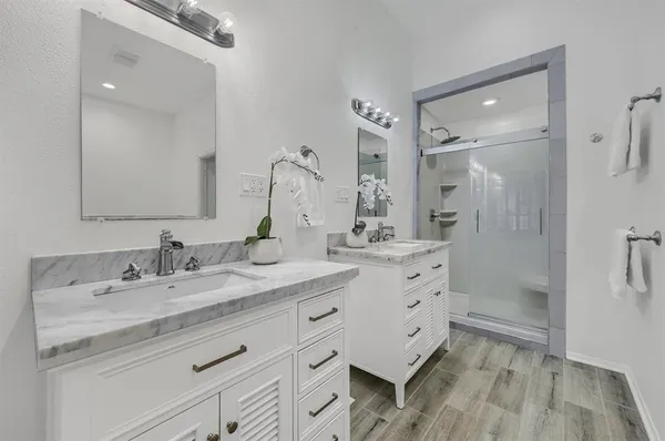 a bathroom with a granite countertop sink mirror and double